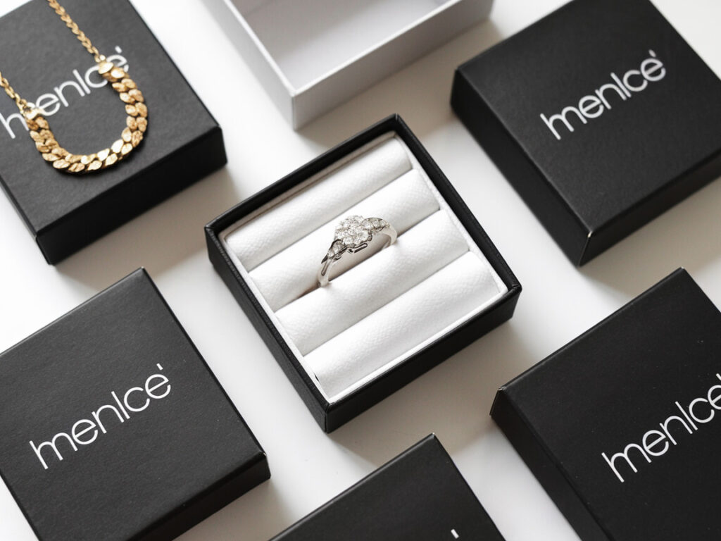 black boxes with the jewelry brand diamond ring and gold necklace