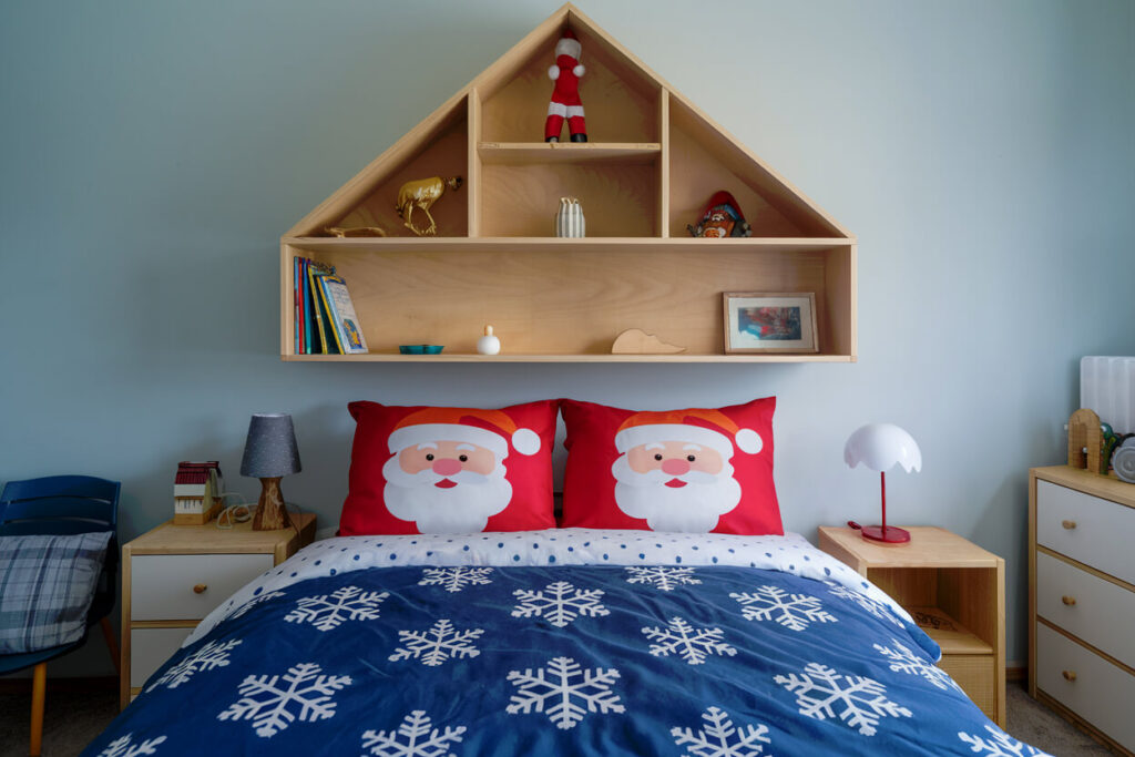 children bedroom with snowflake-patterned duvet and Santa pillowcases