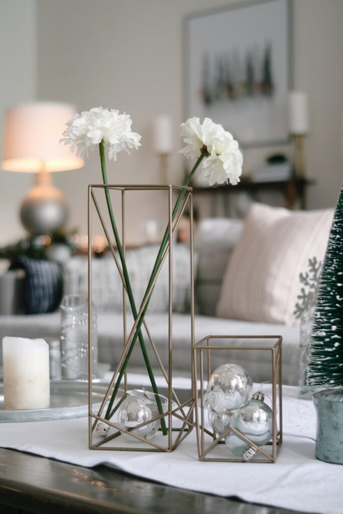 Christmas coffee table decorations geometric metal containers single stem white flowers clear glass ornaments