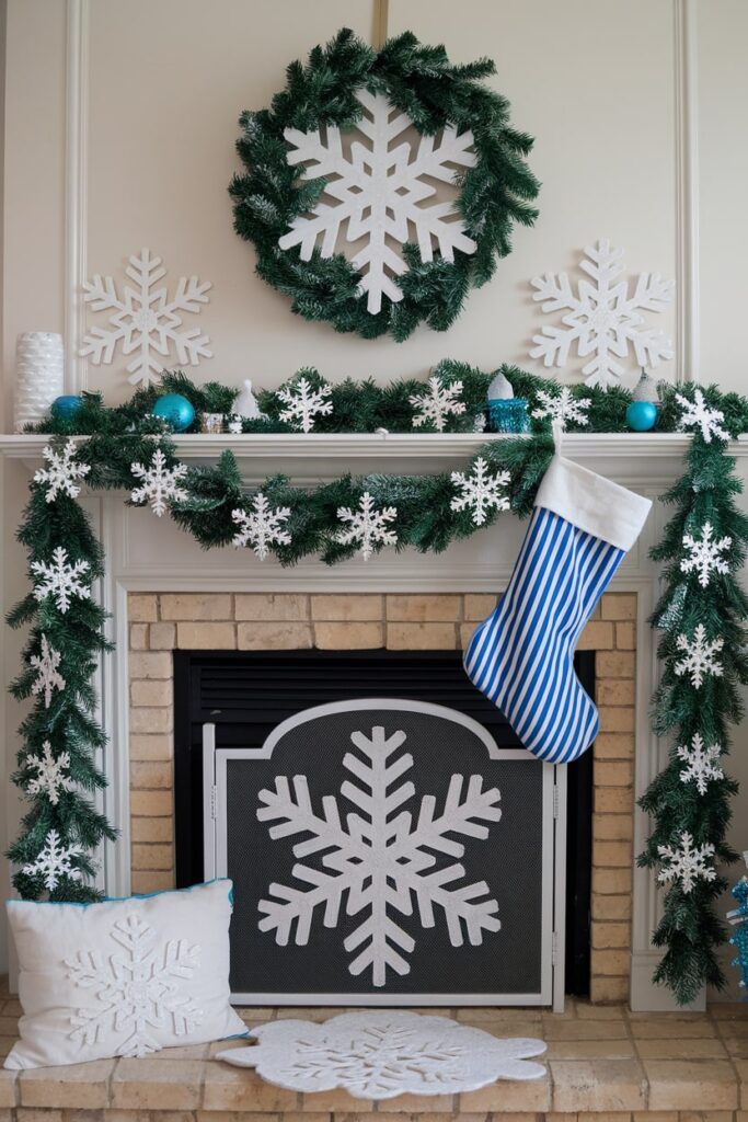 Christmas fireplace mantel with snowflake theme decorations