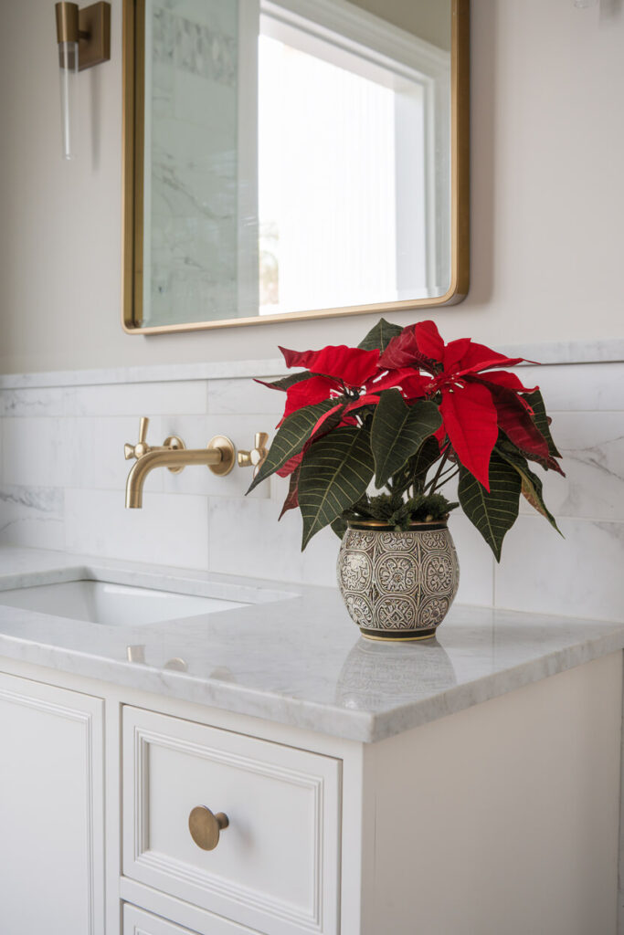 contemporary bathroom design with a faux poinsettia plant as Christmas decor on the marble vanity top