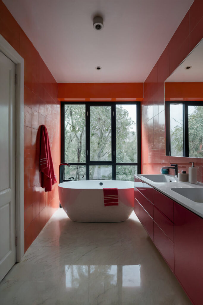 modern bathroom where orange tile and red vanity go together