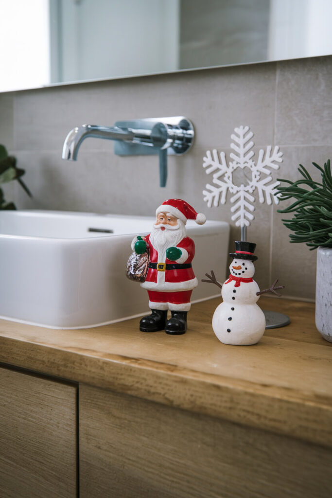 contemporary bathroom with a waterproof Santa, snowman figurines on the vanity top