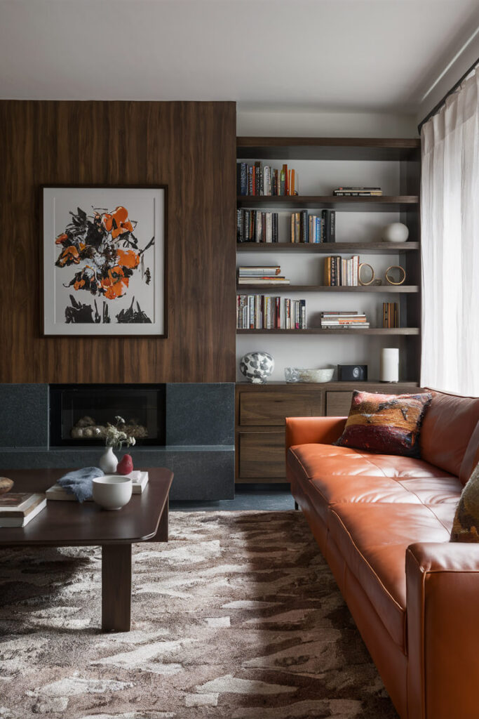 contemporary living room with combination of orange leather couch and brown color shelving