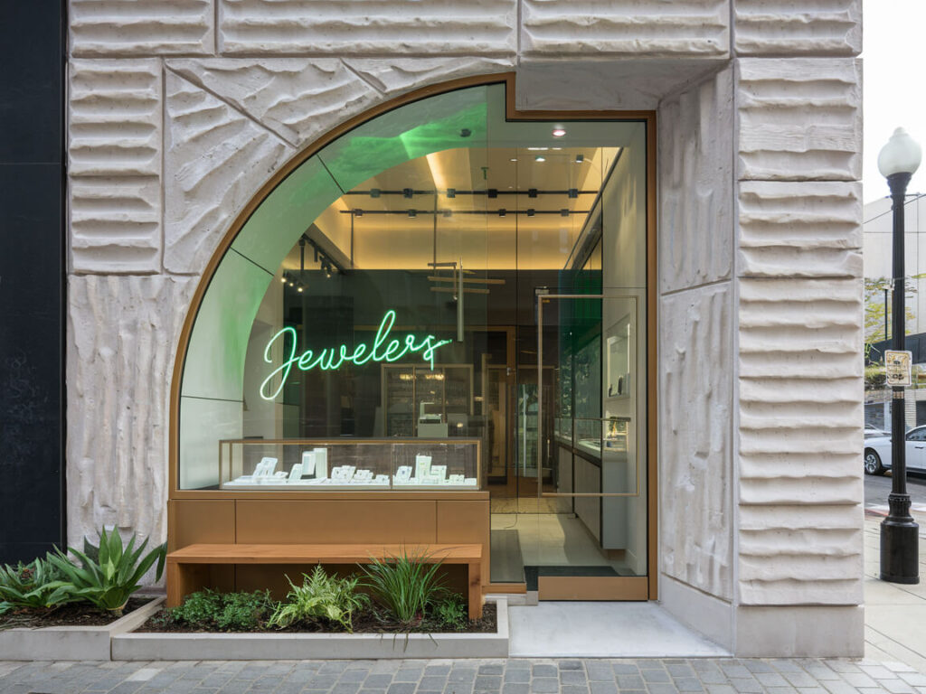 jewelry store with a modern exterior and green neon shop sign