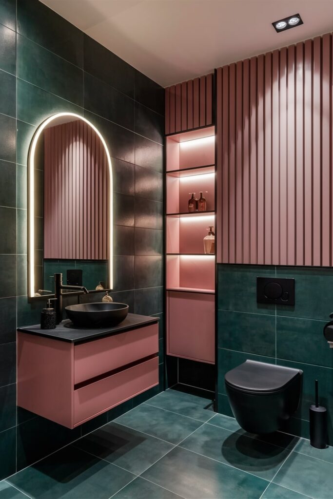 luxurious and modern bathroom with dark green tiles and pink vanity, shelves, cabinets