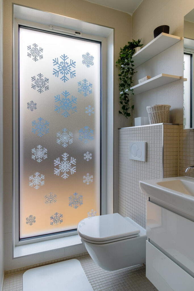 modern bathroom interior features a large window with snowflake decals