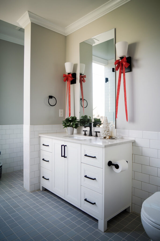 modern bathroom interior sconces with red ribbons Christmas decor idea