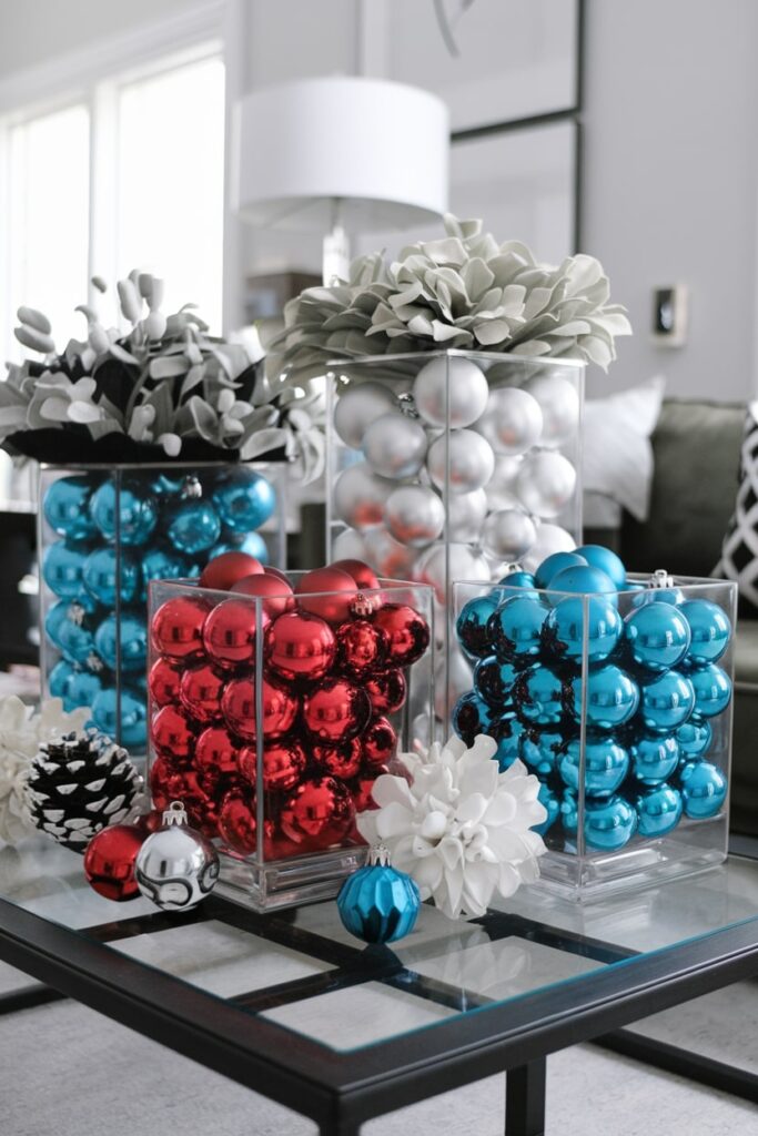 modern Christmas coffee table decor white, blue, and red ornaments in square vessels