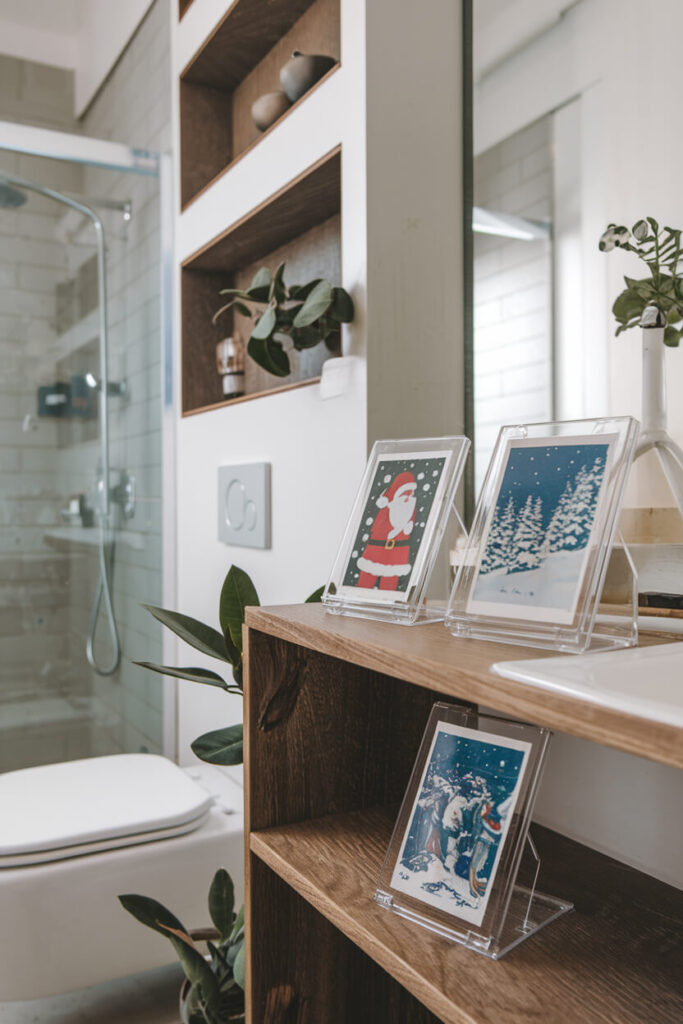 small vintage Christmas holiday postcards in the waterproof photo frames in the light bathroom