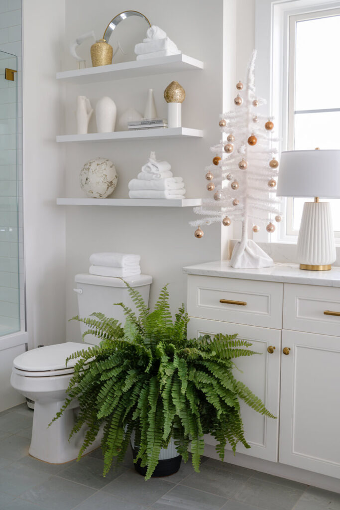 white and gold bathroom decorated with a fern for Christmas