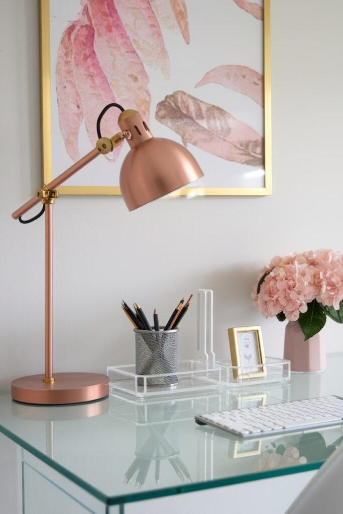 transparent acrylic desk organizers in the feminine home workspace with rose gold desk lamp