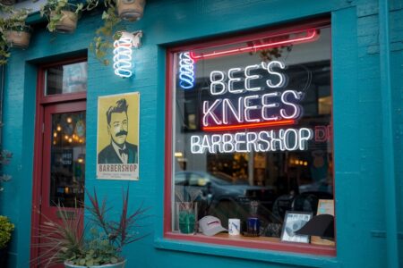 barbershop exterior with poster and neon sign