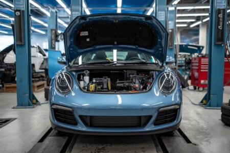car with opened front trunk at the car repair service