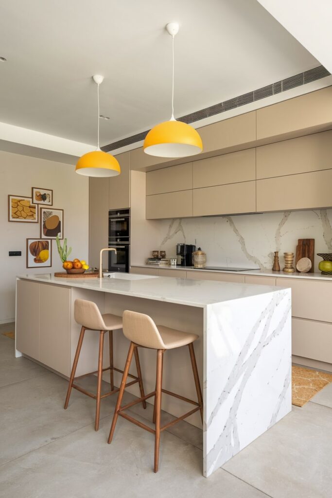 contemporary kitchen with beige color cabinets and bar chairs, yellow pendant lights, white countertops and island