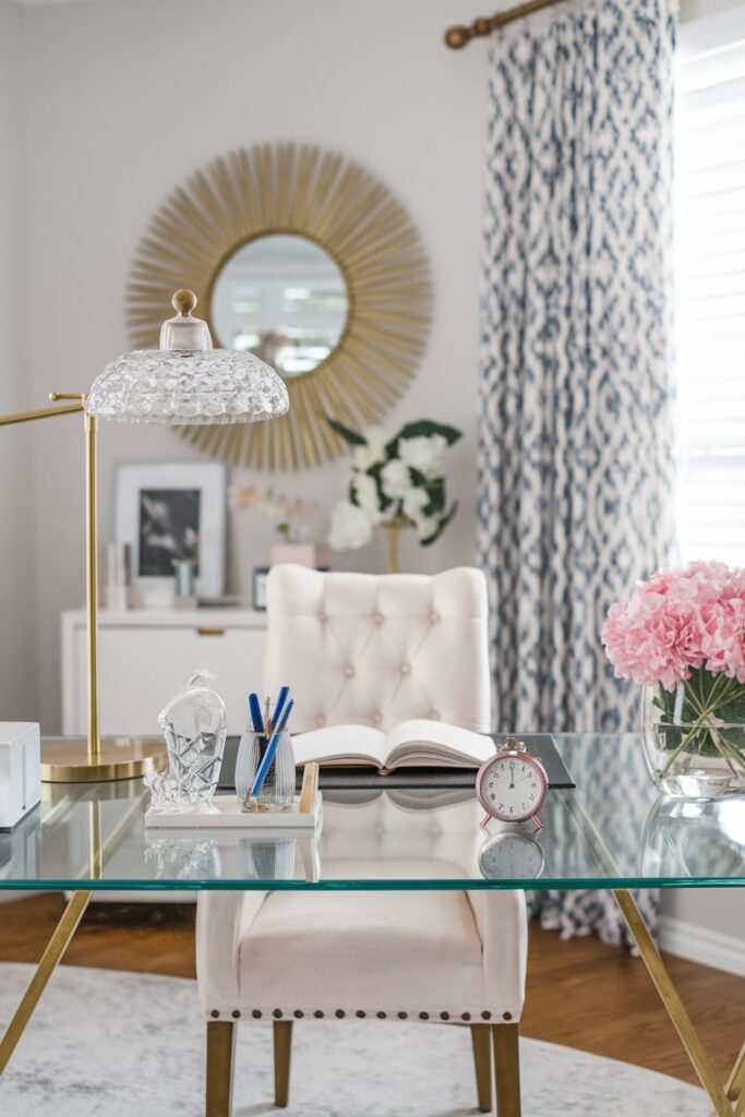 glass desk accessories in feminine home office, creamy white chair