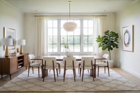 modern white color dining room that goes with a few gentle gold accents, gold table lamps, curtain rod, painting frame