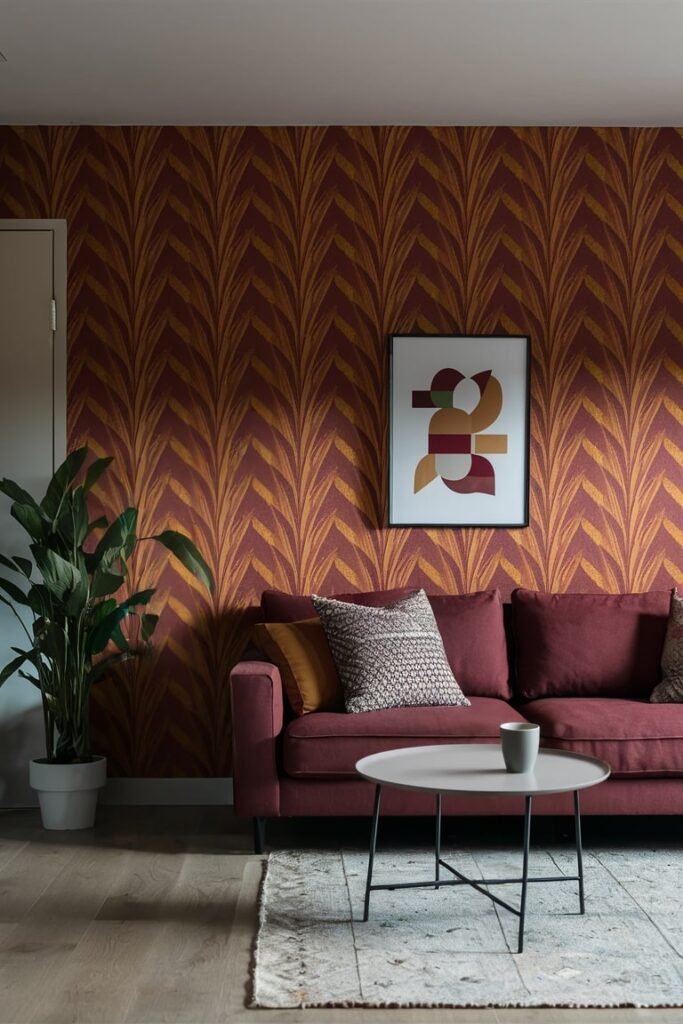 modern living room with maroon and ochre wallpaper, maroon couch, maroon and ochre hues in the wall art