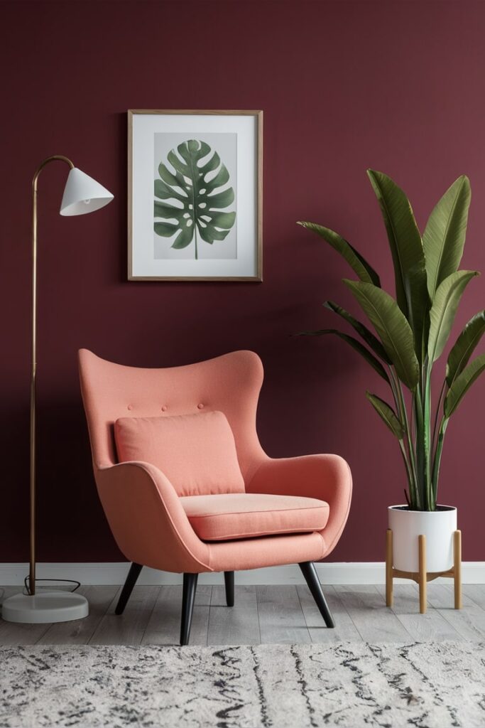 modern peach chair in the living room against maroon walls, leaf wall art, white floor lamp and white plant pot