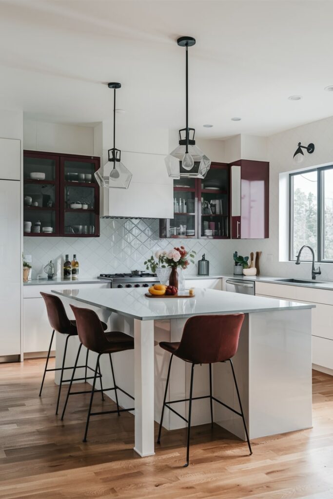 modern white kitchen with maroon accents, maroon upper cabinets and bar chair