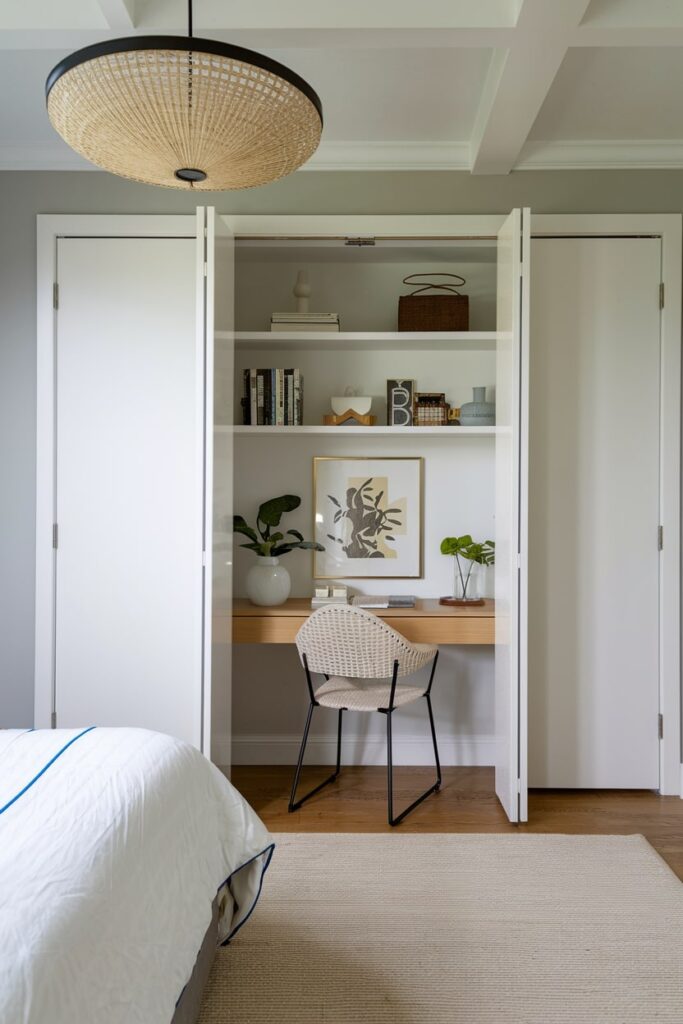 office guest room with white closet conversion, hidden workspace in the closet, white bedding