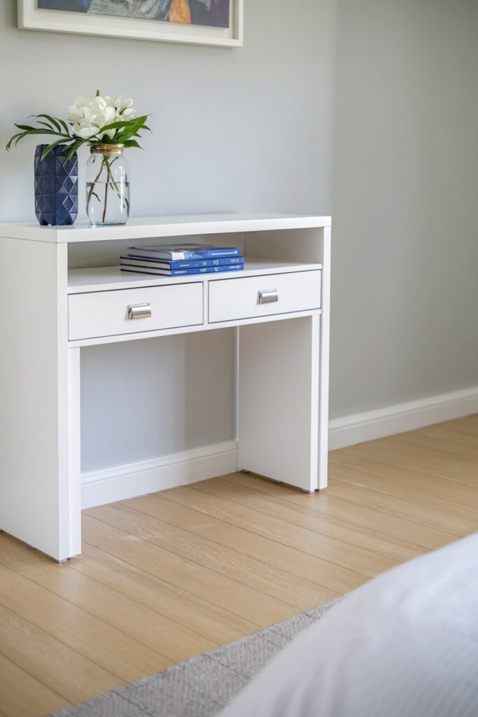 white console table with a hidden desk in the office guest room with light gray walls