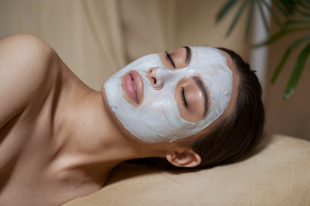 a photo of a female model with a white beauty mask in a spa