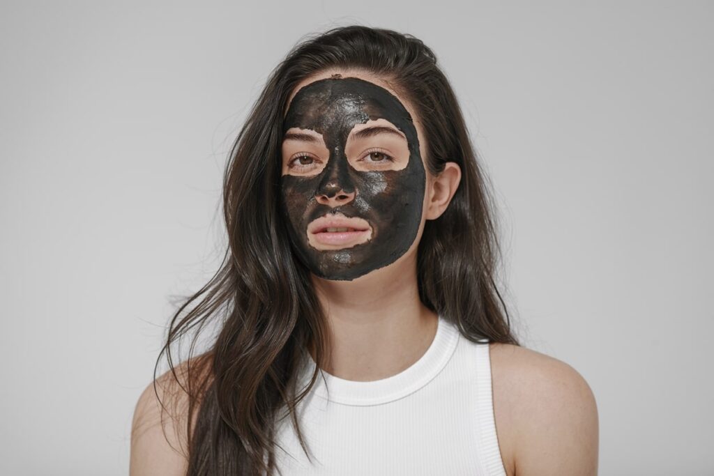 a photo of a female model with a dark beauty mask