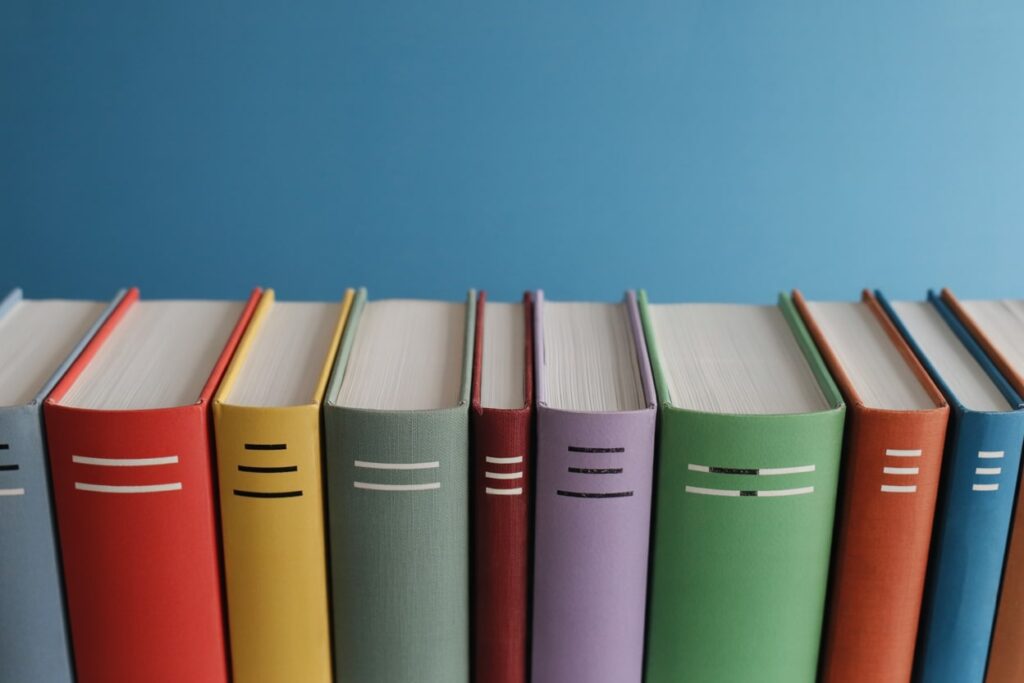 row of colorful books, blue background
