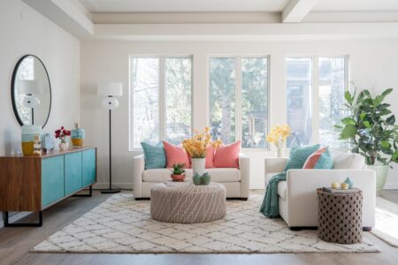 modern living room with summer inspired decor, blue and pink color accents, orange floral decor