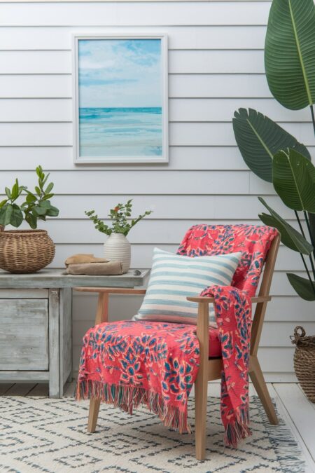 red vibrant throw blanket on the wooden chair summer decor