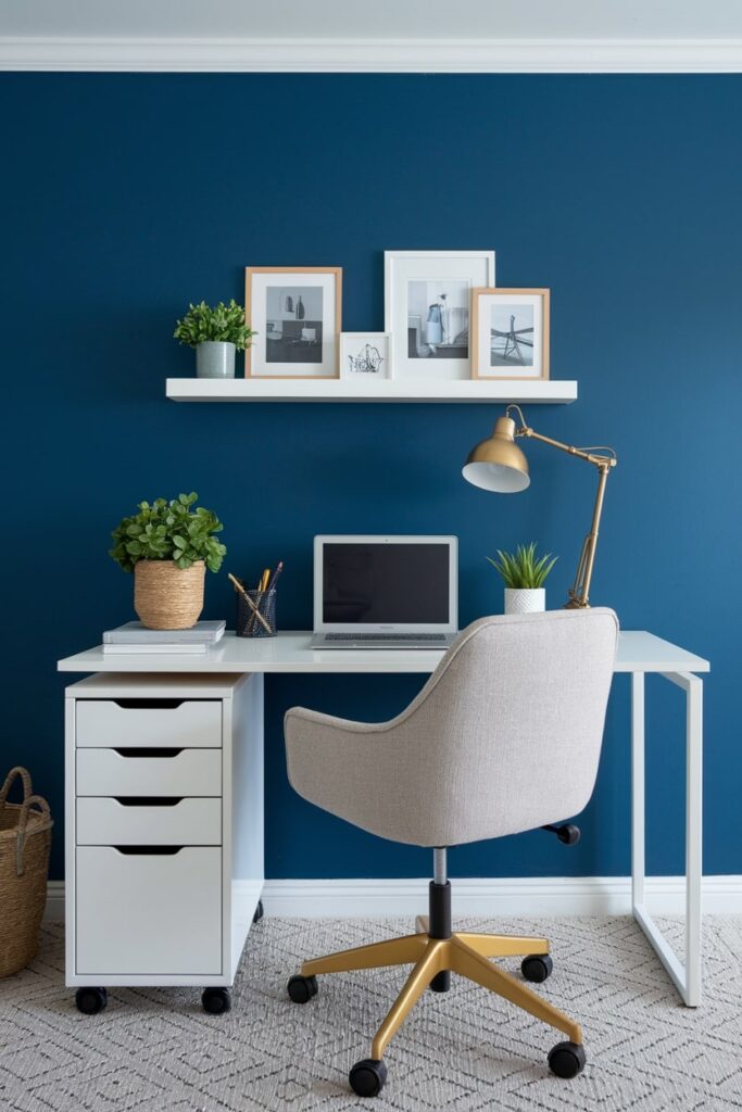 small workspace, blue wall, white desk and shelf, light gray chair on wheels