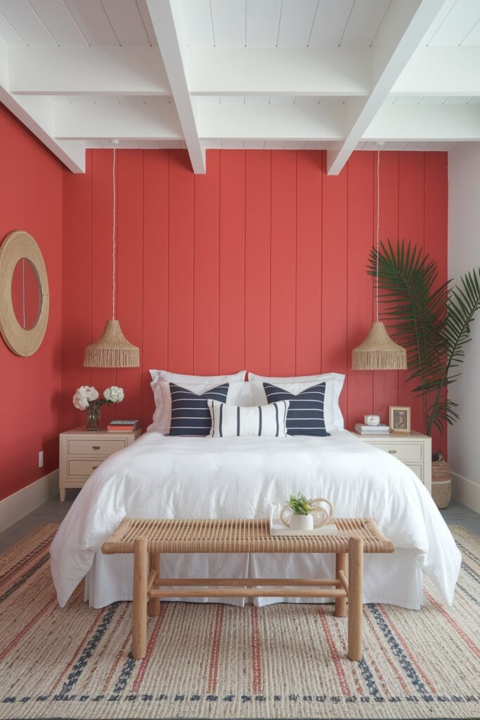 bedroom with coral red wall, white bedding that creates a beachy feel