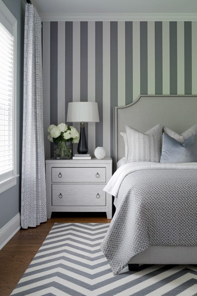 modern gray bedroom with geometric patterns on wallpaper and area rug