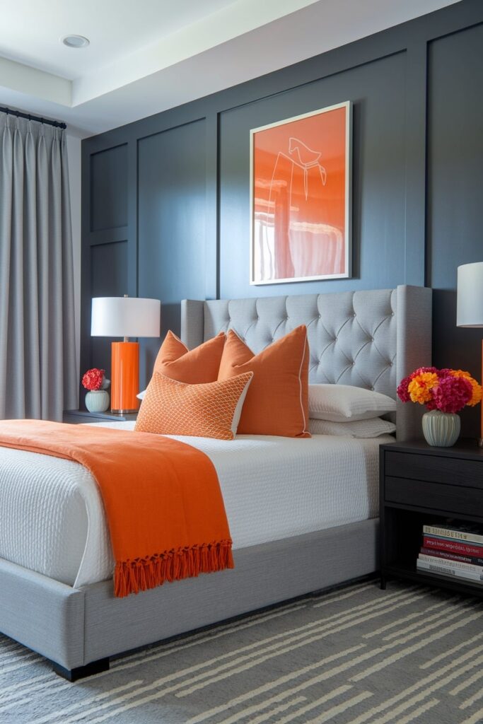 modern gray bedroom with orange accent bedding and decor