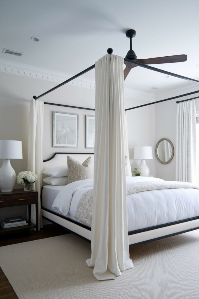 modern white bedroom with black canopy bed frame and white curtains