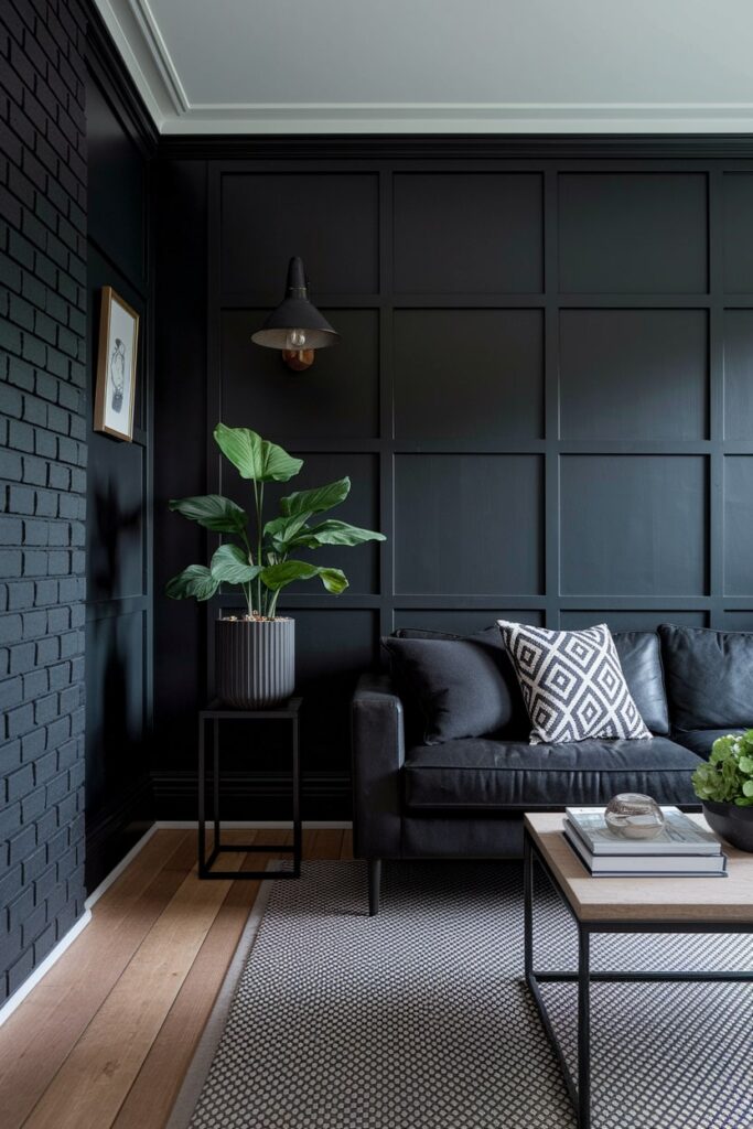 black living room with brick and board and batten walls, black couch and furniture frames