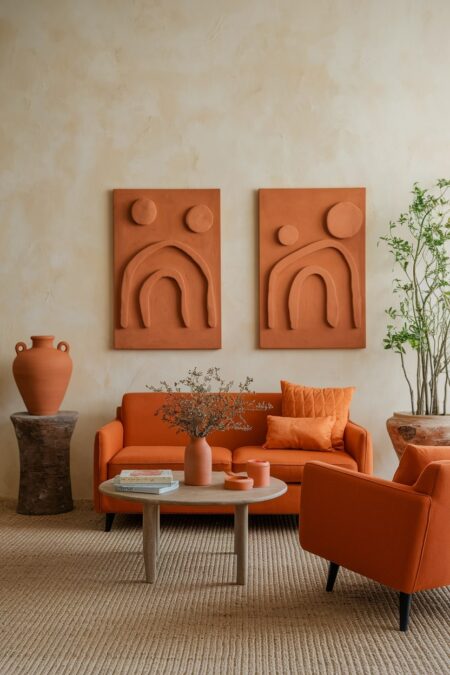 living room with cream limewashed wall orange furniture and terracotta accessories