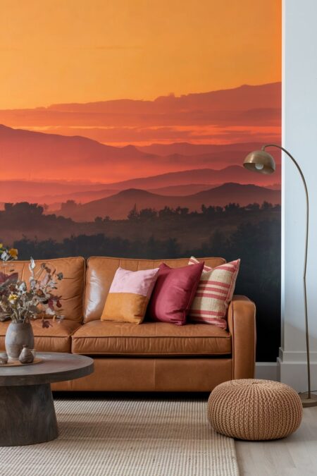 living room with sunset-inspired wallpaper in orange palette and leather couch