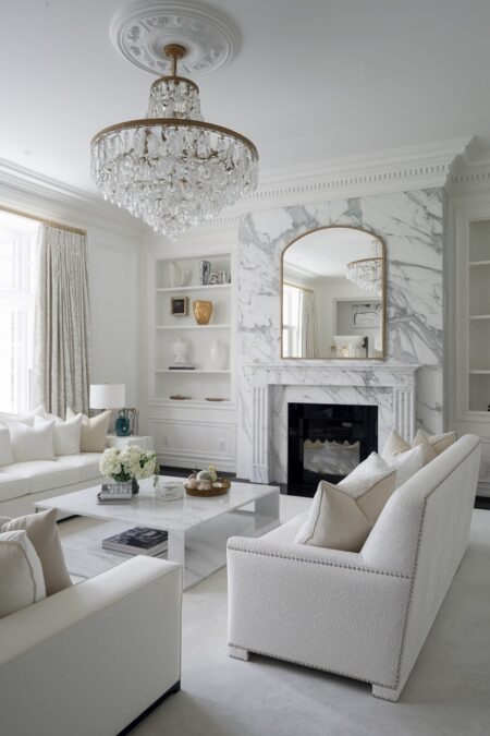 luxury white living room with marble fireplace and crystal chandelier