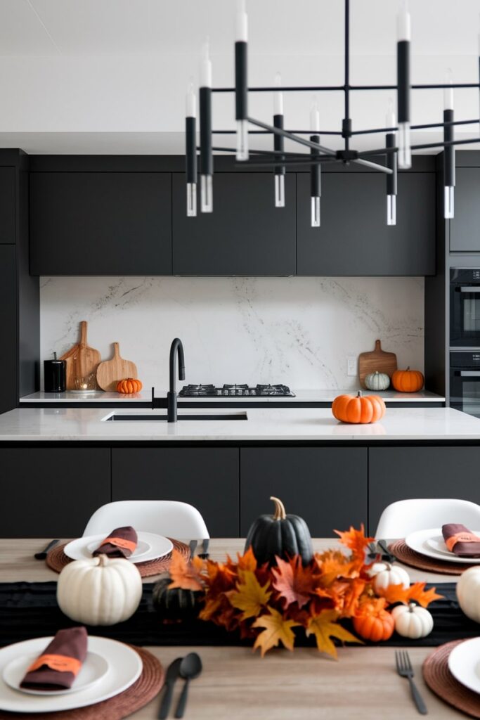 modern black kitchen with Halloween-themed table decor, black table runner, autumn leaves, small pumpkins