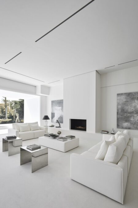 modern minimalist white living room with geometric shapes and stainless steel accents