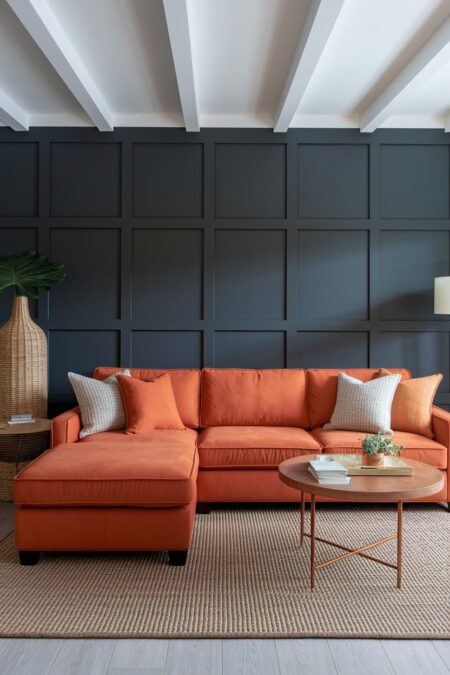 orange living room has charcoal gray wall with board and batten and burnt orange sectional sofa