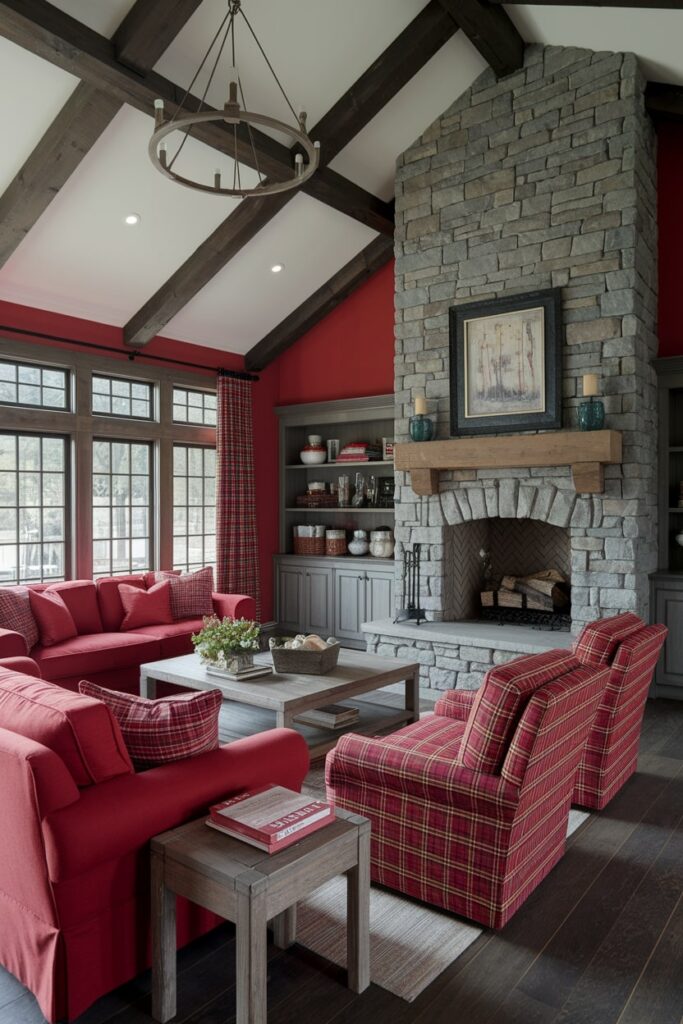 rustic red living room with exposed ceiling beams, red plaid textiles, and stone fireplace
