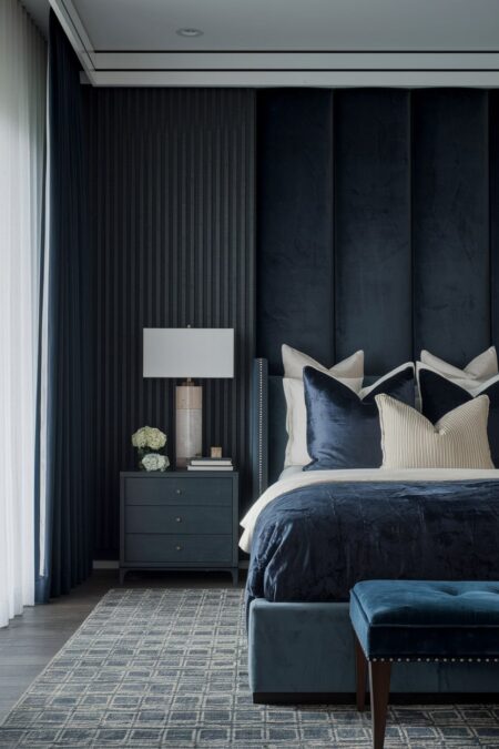 dark bedroom with luxury curtains and charcoal velvet wall panels