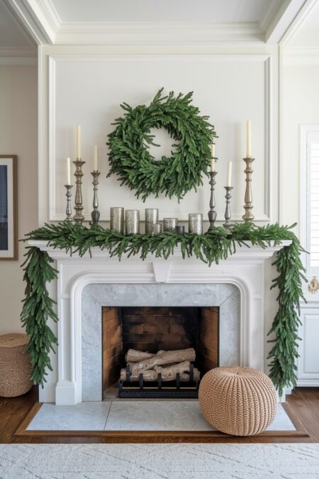 fireplace with lush garland and mercury glass candlesticks on the Christmas mantel
