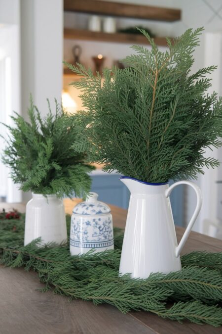 fresh greenery in enamelware pitchers as Christmas decor
