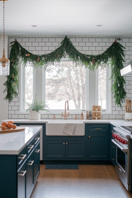 kitchen with a garland draped over windows as Christmas decor