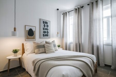neutral cozy bedroom with gray throws and curtains