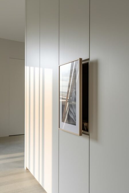 living room with a hidden storage behind framed artwork